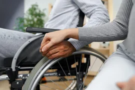 close-up-female-touching-hand-disabled-man-wheelchair-support_93675-126013.avif