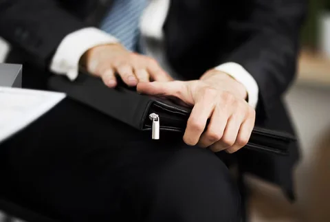 confident-businessman-with-folder-his-hands-office_160672-13841.avif