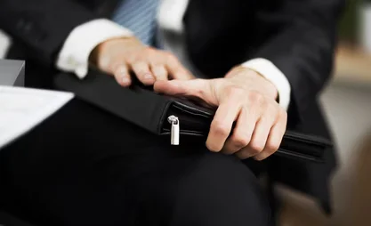 confident-businessman-with-folder-his-hands-office_160672-13841.avif