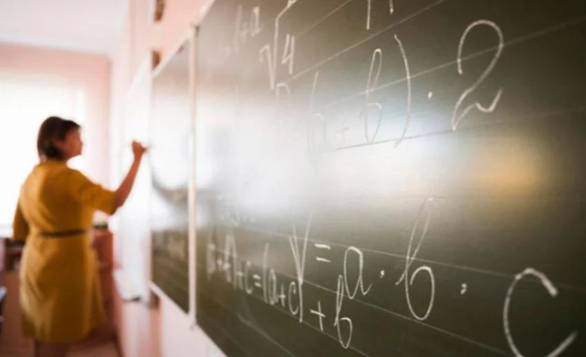 portrait_teacher_writing_on_chalkboard.jpg
