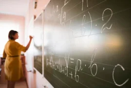 portrait_teacher_writing_on_chalkboard.jpg